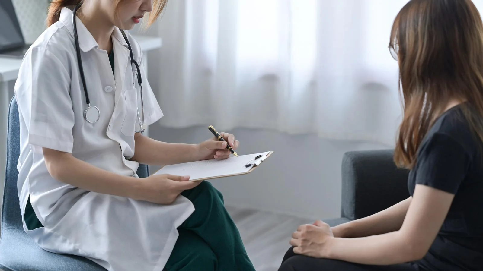 Professional psychologist consulting with patient at psychotherapy session. Healthcare and medical concept.